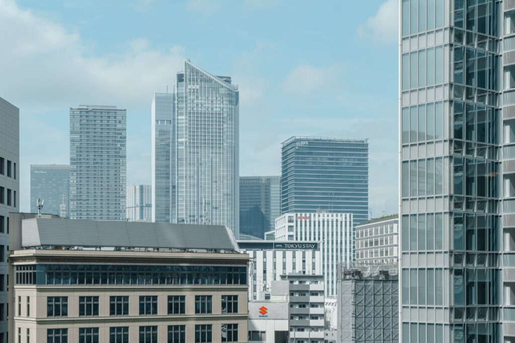 Cityscape featuring glass skyscrapers under a clear blue sky, ideal for urban themes.